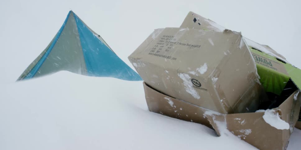 Cardobard boxes and a tent in a blizzard