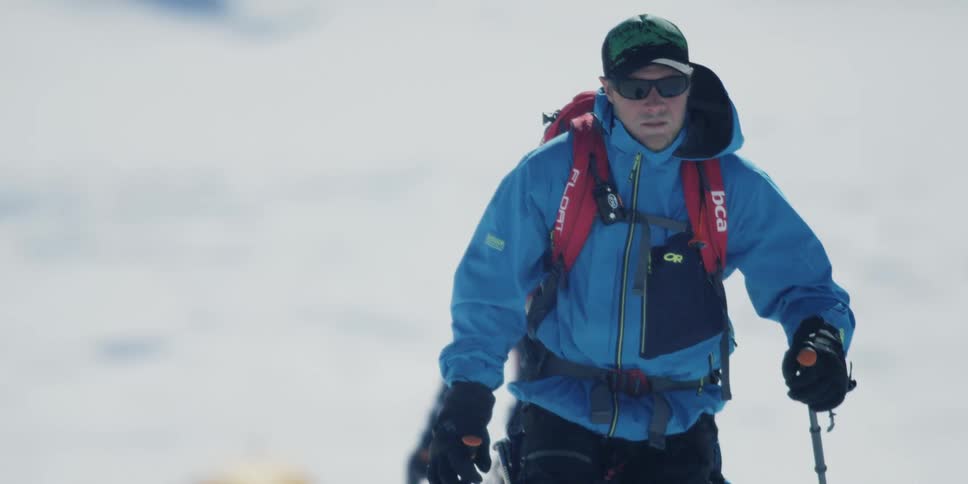 A skier treks across a snowy area