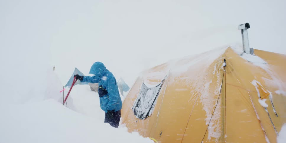 The person removes snow with the shovel