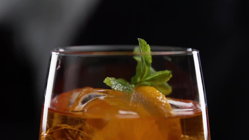 Mint drops in to a cocktail