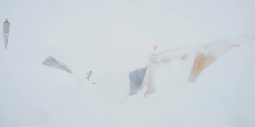 A person opens and enters his tent in an intense blizzard