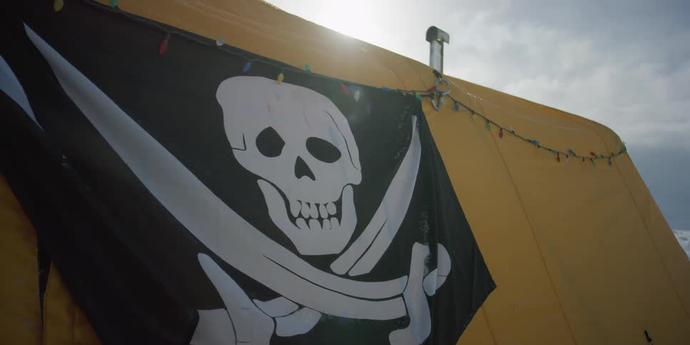 A tent with a pirate flag on it