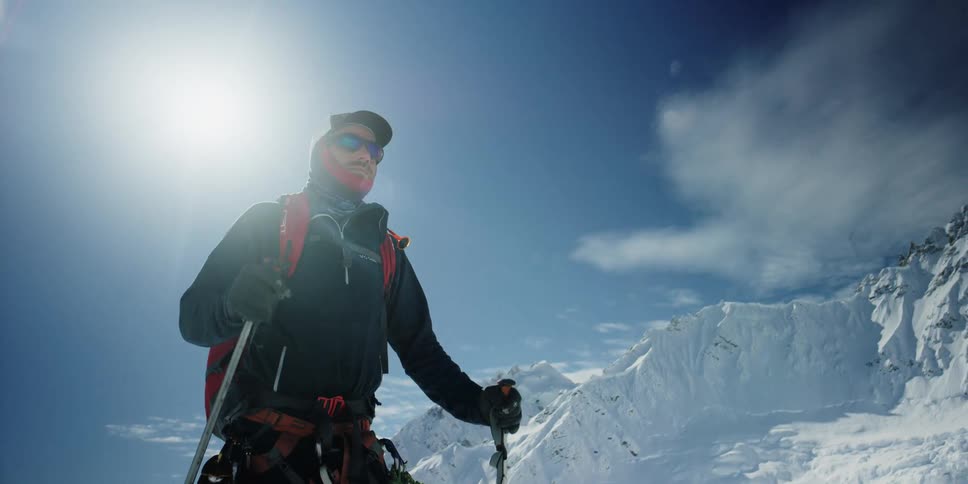 A man moves through the snowy mountains