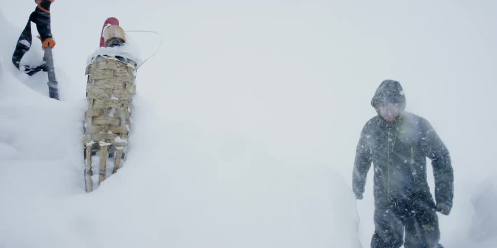 A man walks through an intense snow storm
