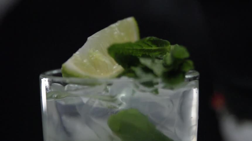 A drink with liquids and ice is displayed