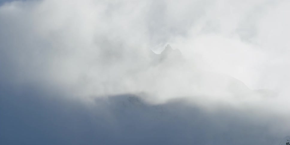 Clouds float around the mountain