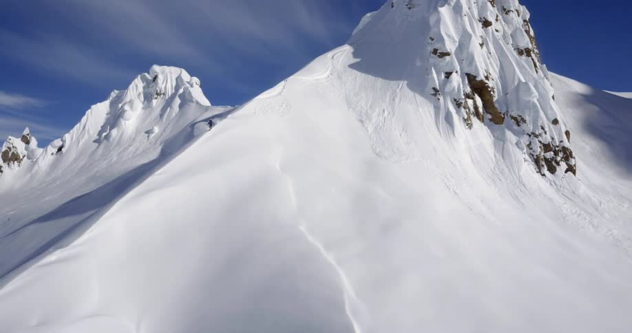 Impressive aerial of skier on mountain ridge
