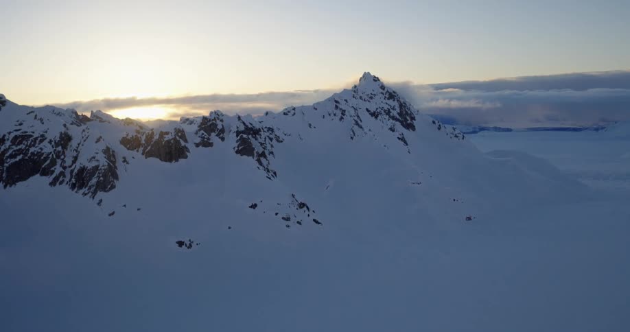 Aerial view of the snow covered mountains at dusk