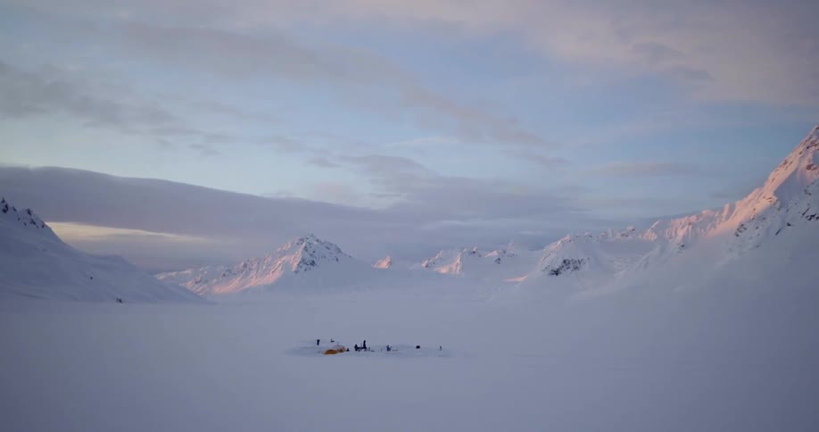 Aerial flying over a camp in remote mountains