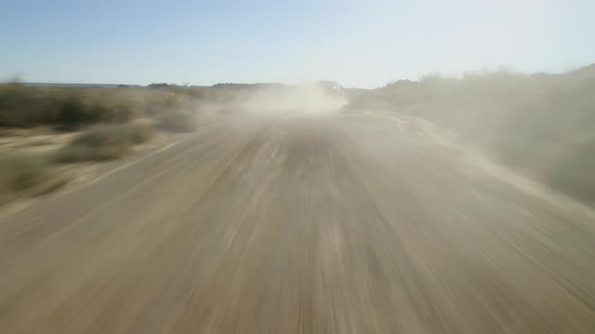 The vehicle drives quickly down the road
