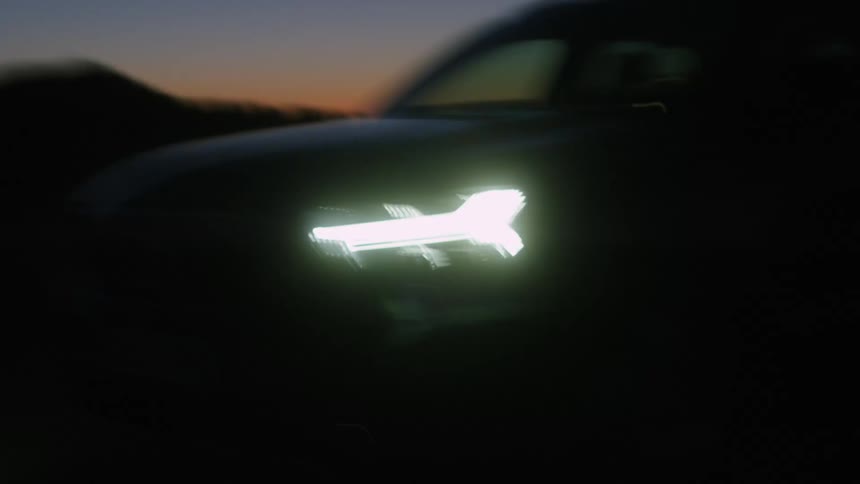 Shaky footage of a car driving with its lights on