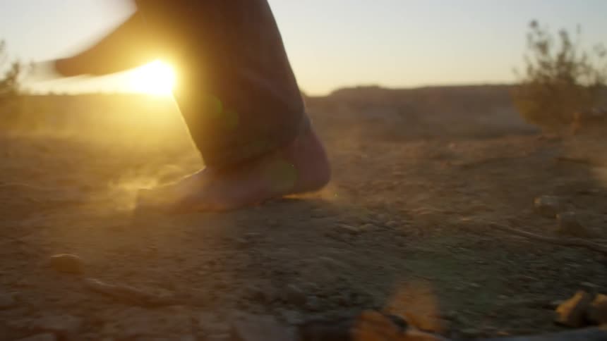 A person dances at sunrise