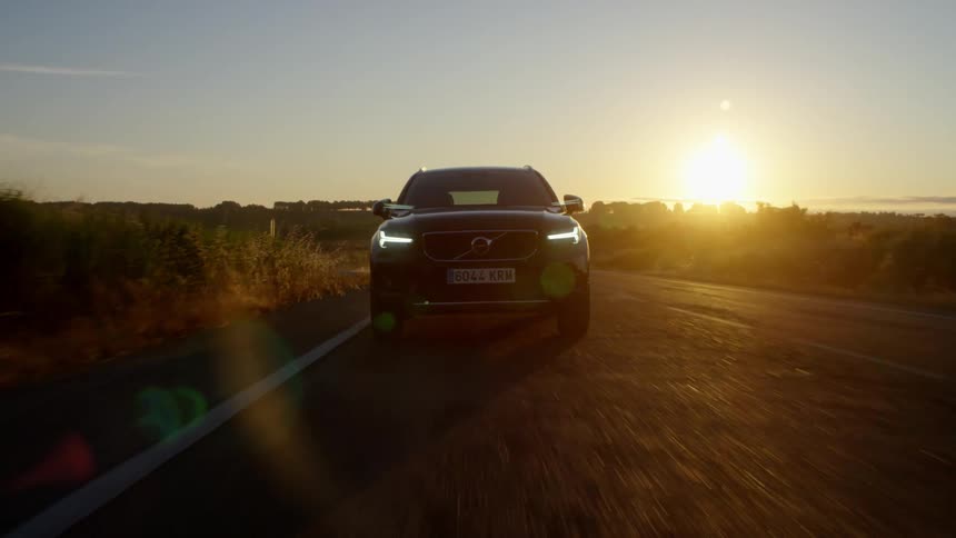 The car enters the road and starts driving fast at sunset