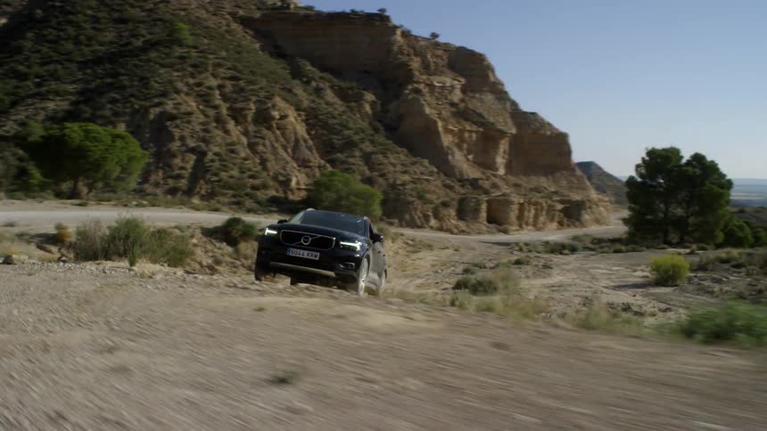 The car drives on a dirt road