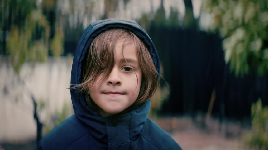 A boy smiles as he poses for a photo