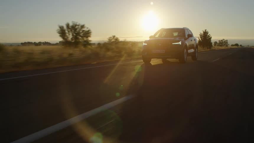 Car drives along the highway at sunset