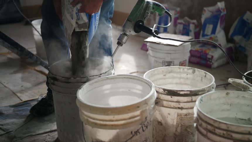 Concrete powder is poured into a bucket
