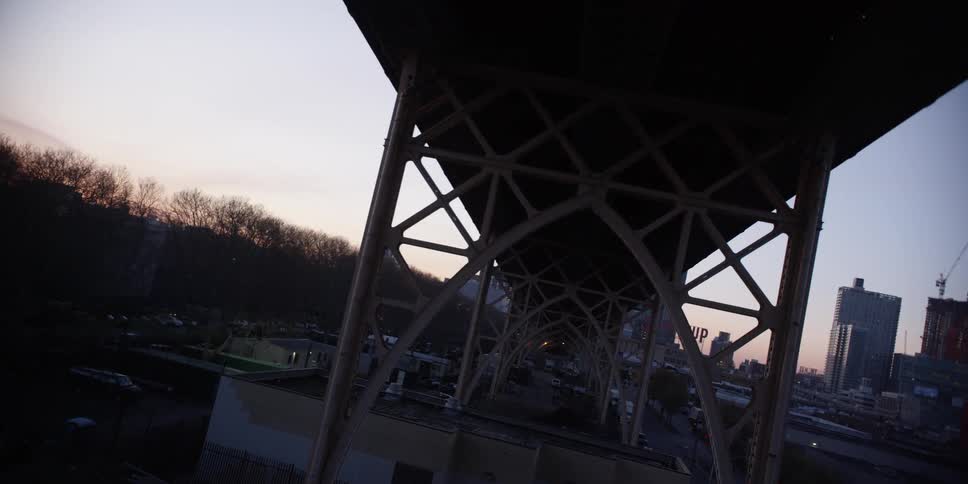 Aerial view of the underside of an elevated roadway in an urban setting