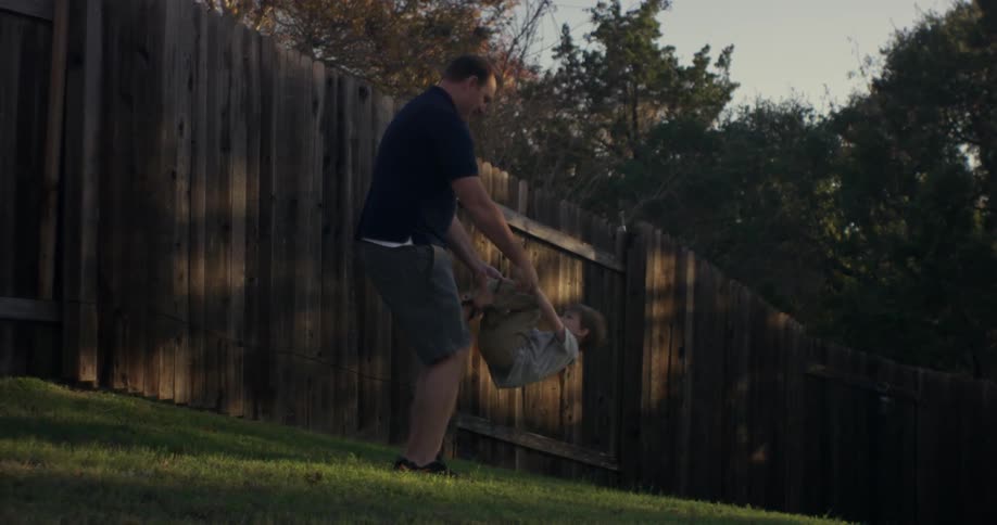 A boy walks over to a man and he flips him over
