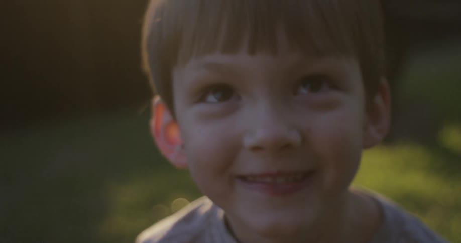 A young boy smiles on a sunny day
