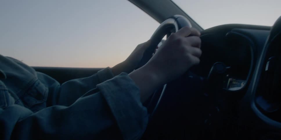 Side view of a woman driving her car