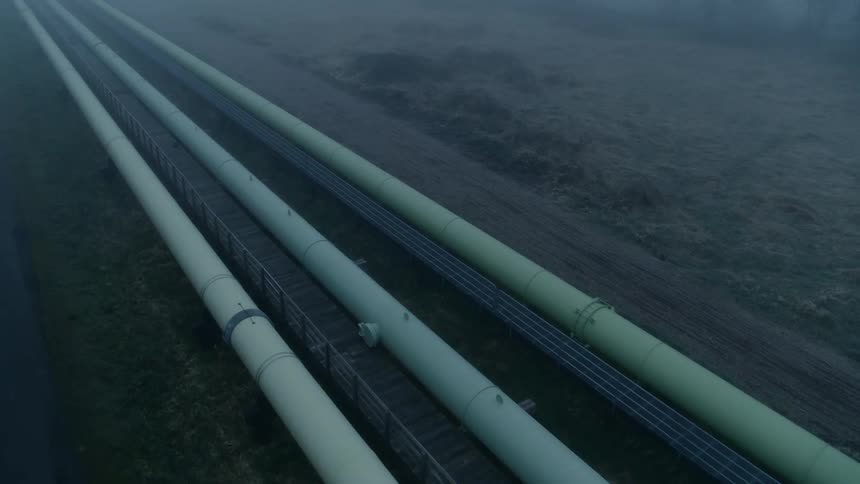 Tilt up traverse along multiple pipelines that extend to the horizon and beyond amidst dense fog