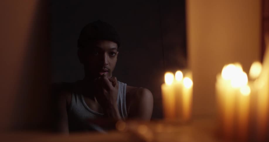 A man is looking at his reflection in the mirror