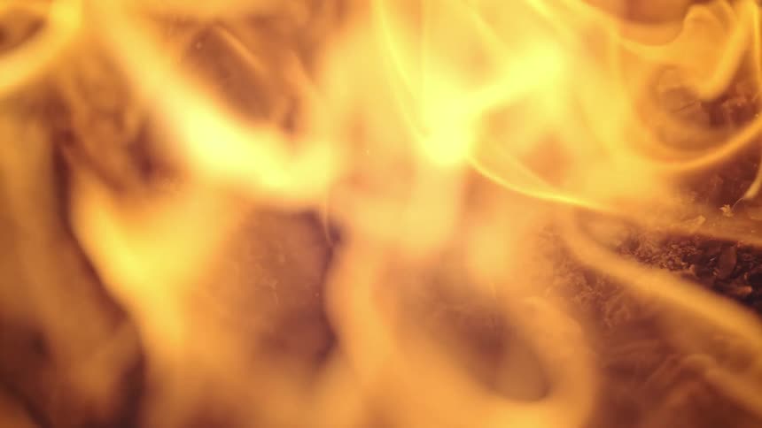 Close up of flames bursting as they ignite in slow motion