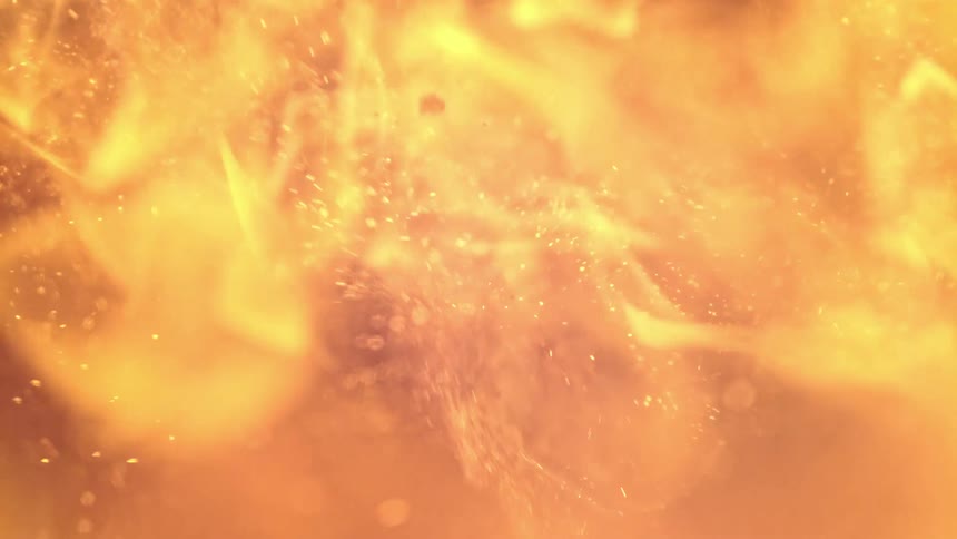 Pieces of wood fly as fire burns
