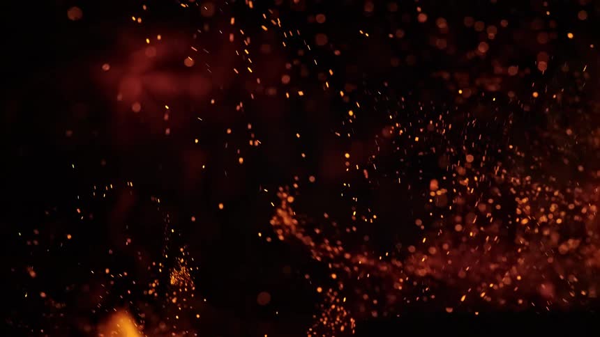 Orange dust rises and billows against a dark background