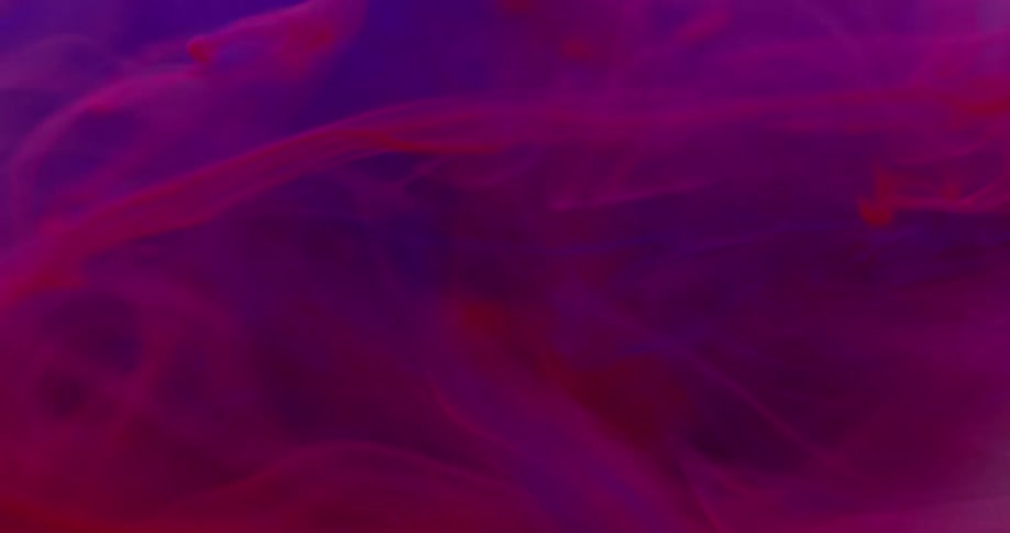 Ink tendrils floating in a colored solution