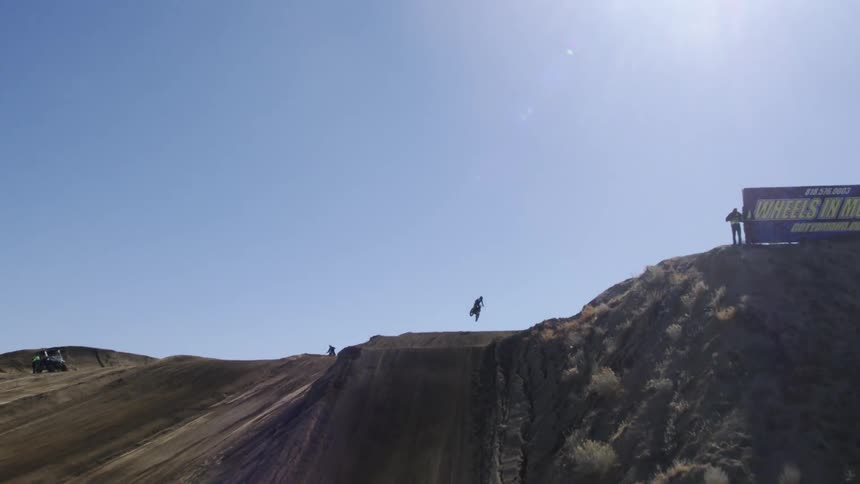 A bmx rider jumps over the hill