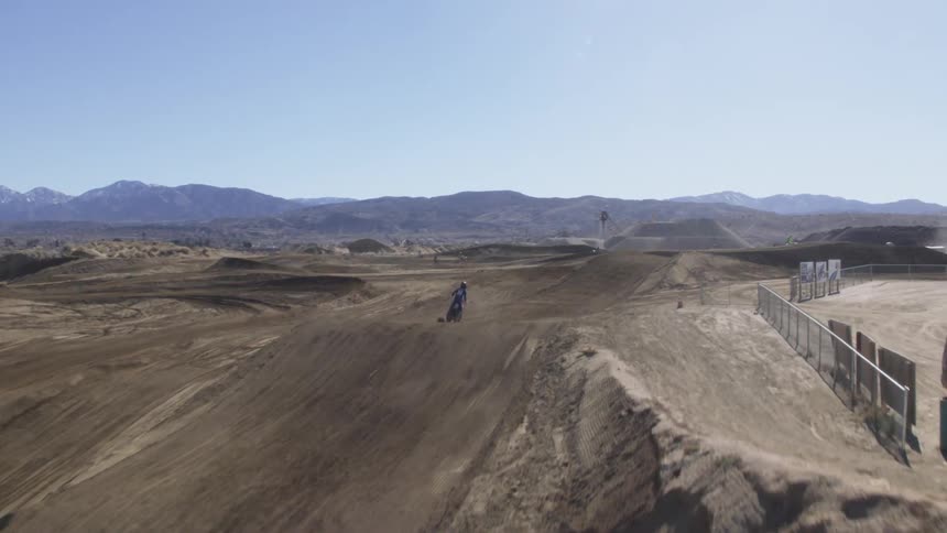 People are riding dirt bikes in a desert area