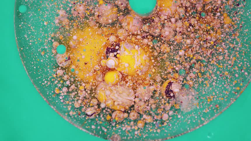 Abstract art with colored particles moving in liquid