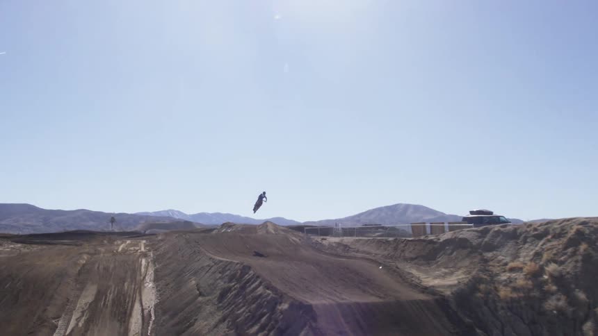 Motocross riders race around a dirt track