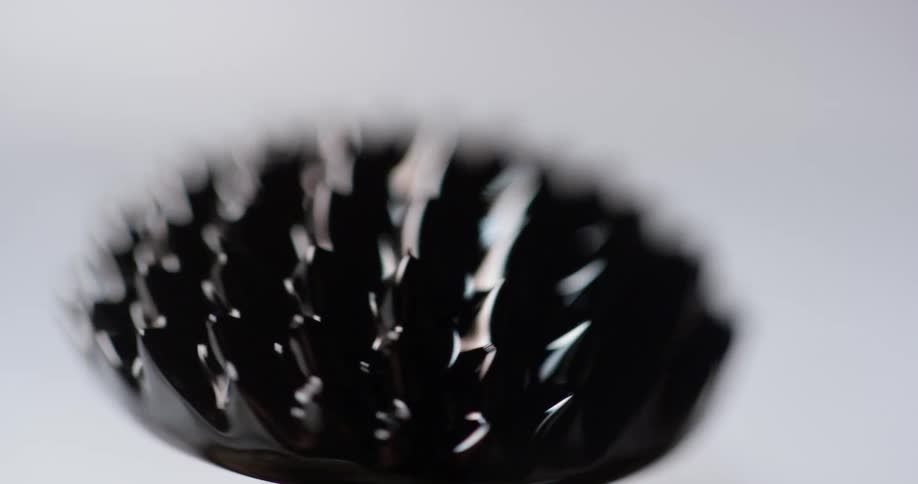 An abstract object with bristles spins