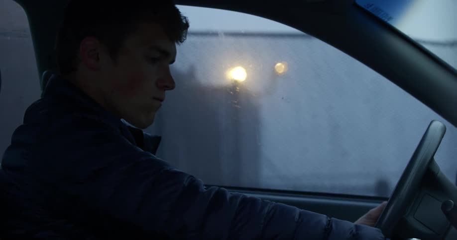 Side view of a man starting the car