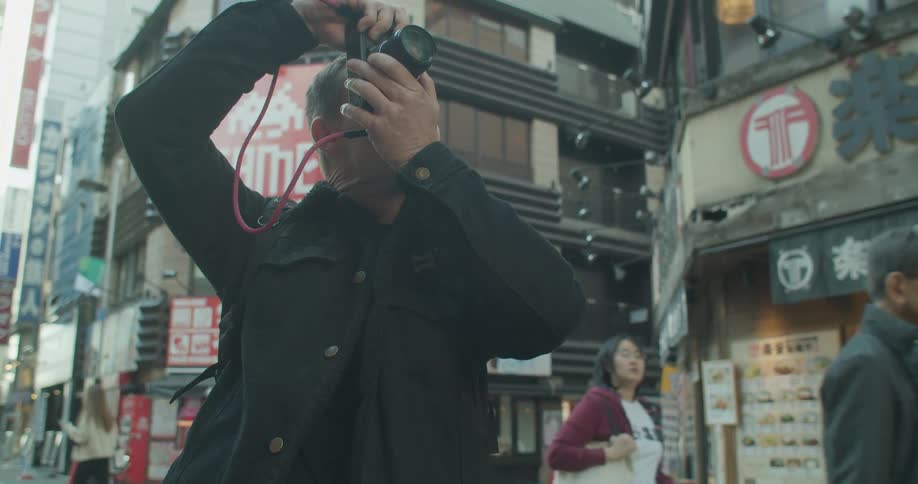Man photographs buildings in the city