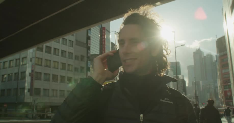 Man answers the phone in the street
