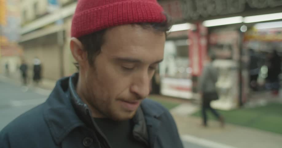 A man is taking pictures outdoors in a city