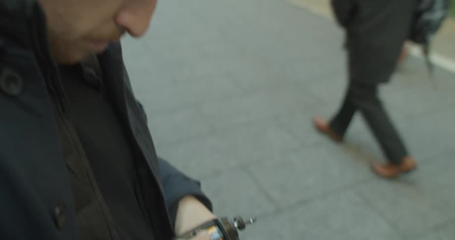 A white man puts a roll of film into a camera