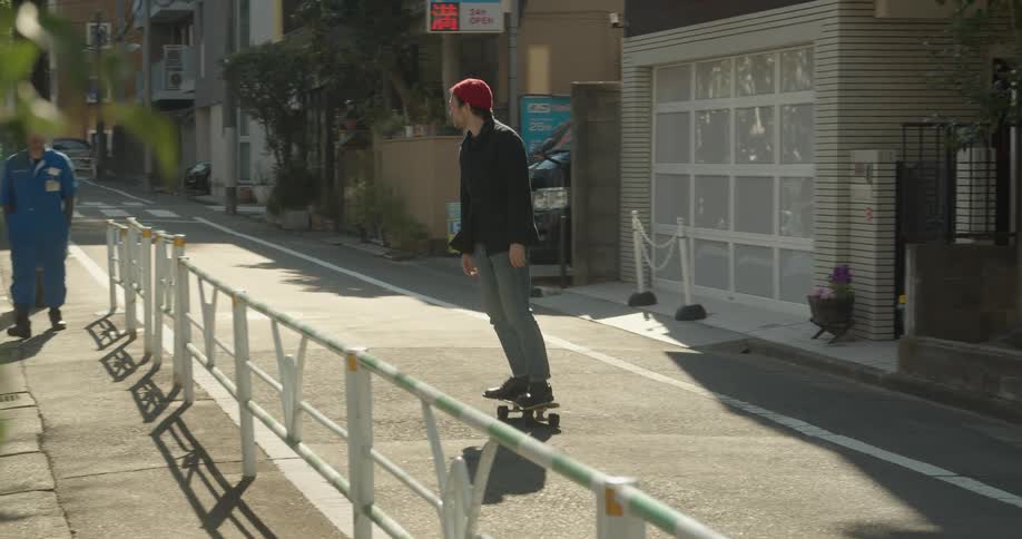 Man rides on a skateboard in the street