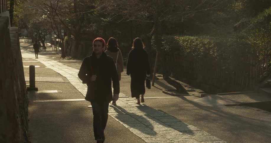 Man walks along the boulevard and says hello to the women