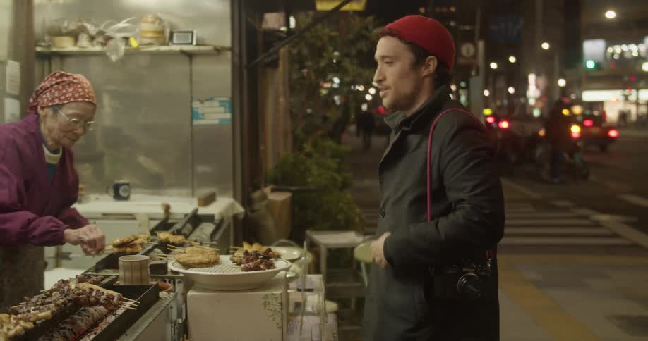 A food truck employee gives change back to a male customer