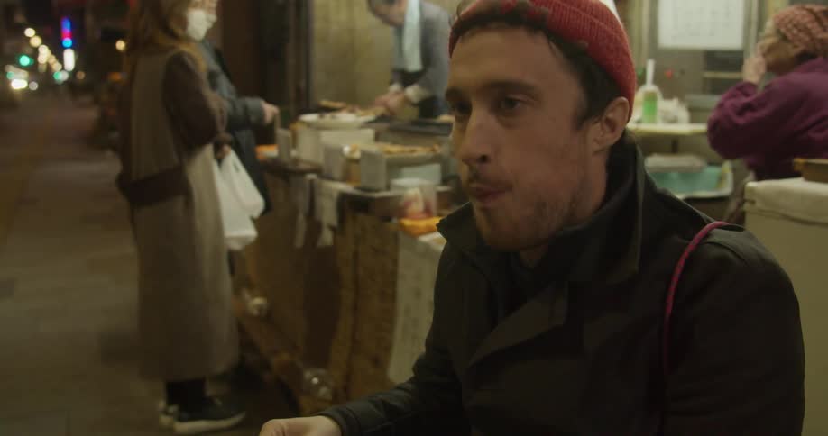 People are outside eating at a market