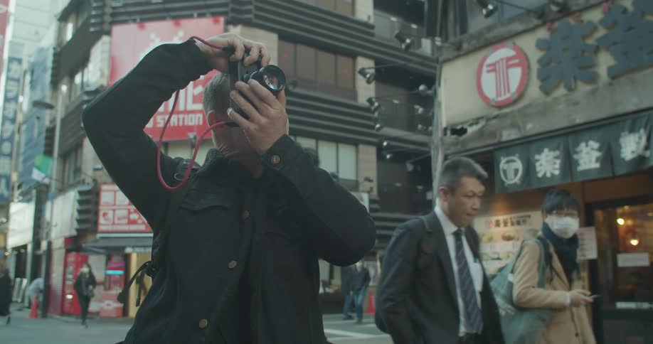 Man photographs buildings in the city