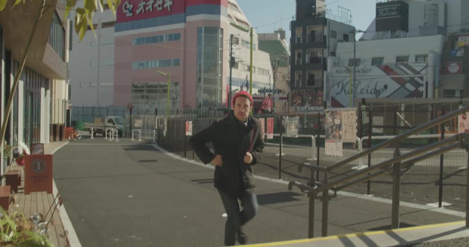 A man walking in a foreign country checks his phone