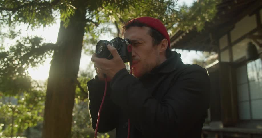 A man is taking pictures outdoors