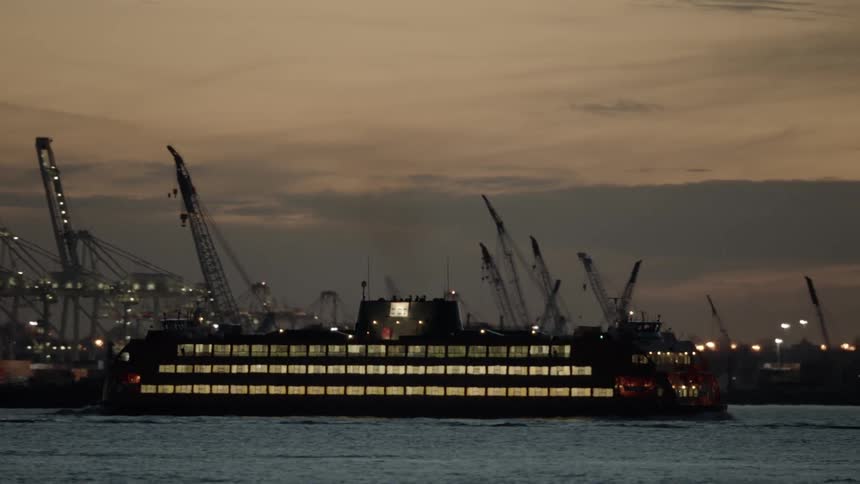 Ferryboat travels across the sea at dusk