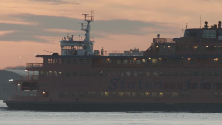 Ferry boat travels across the sea at dusk